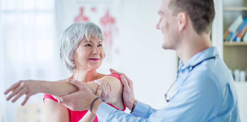 A woman is receiving physical therapy for arthritis pain relief